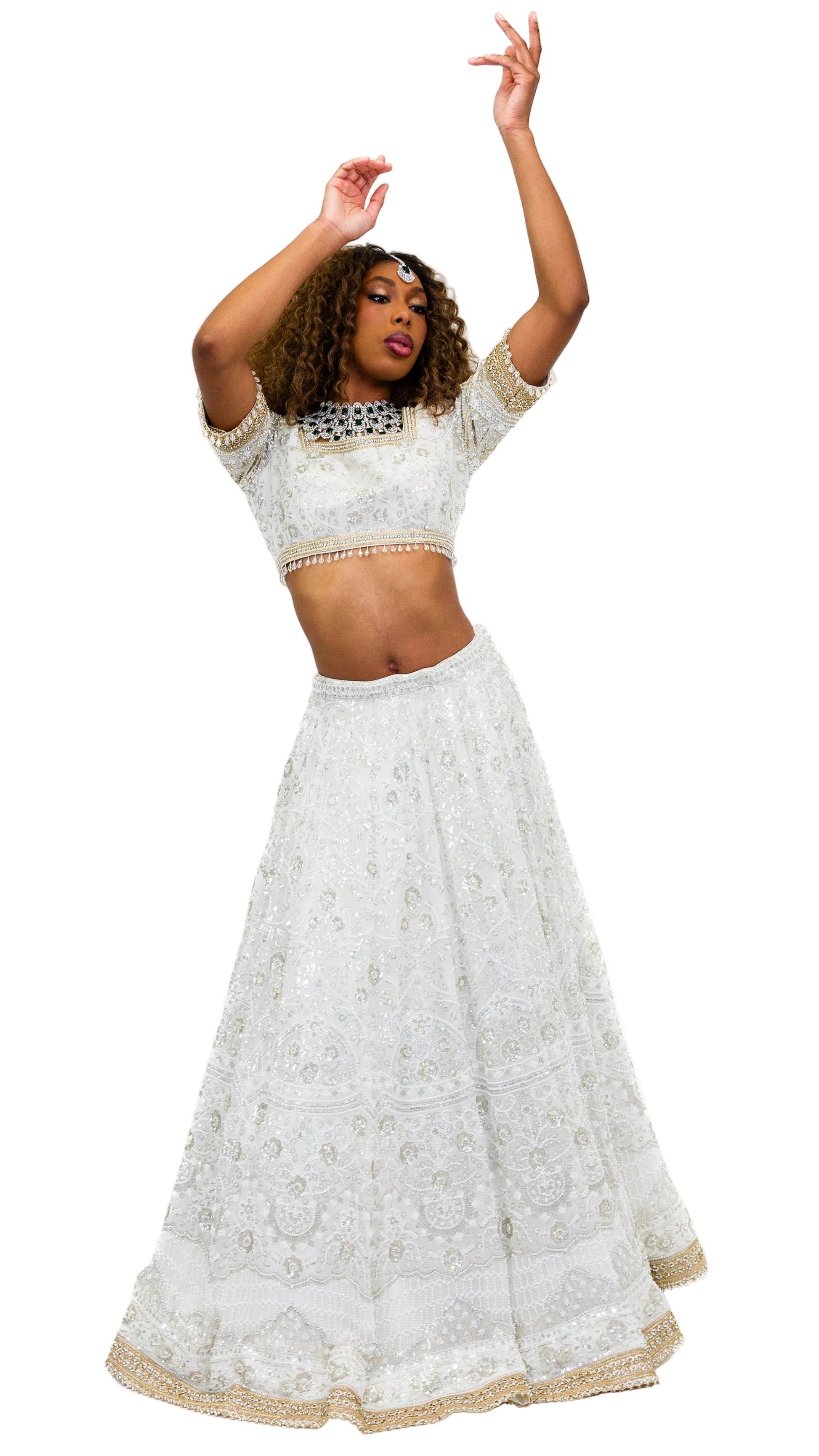 Woman wearing a white embroidered outfit on a white background